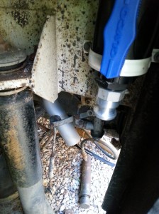 Drain point for the Gray water system, the silver pipe behind is the exhaust pipe for the diesel hot water system.