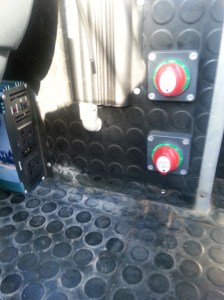 The selection switches for the Battery banks, (front & rear) these switches allow for selection of battery banks to individually supply power, receive charge from the Solar array or be coupled together as 1 bank. the item to the left of the upper switch is a Redarc 1240dc-dc charge controller which will supply charge to the bank currently in use when the Vehicle engine is running.